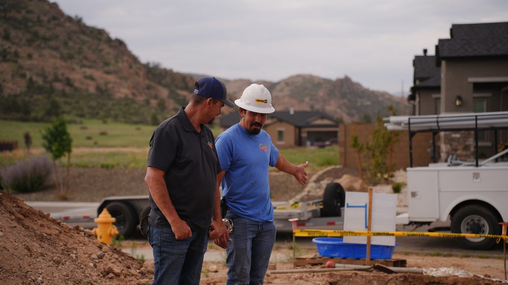 Grading Specialists crew walking a residential site together, discussing the work